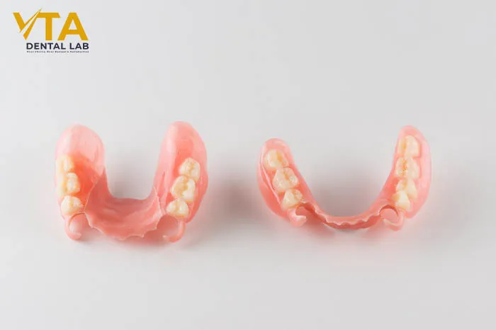 Acrylic partial denture showcasing flexible tooth replacement design
